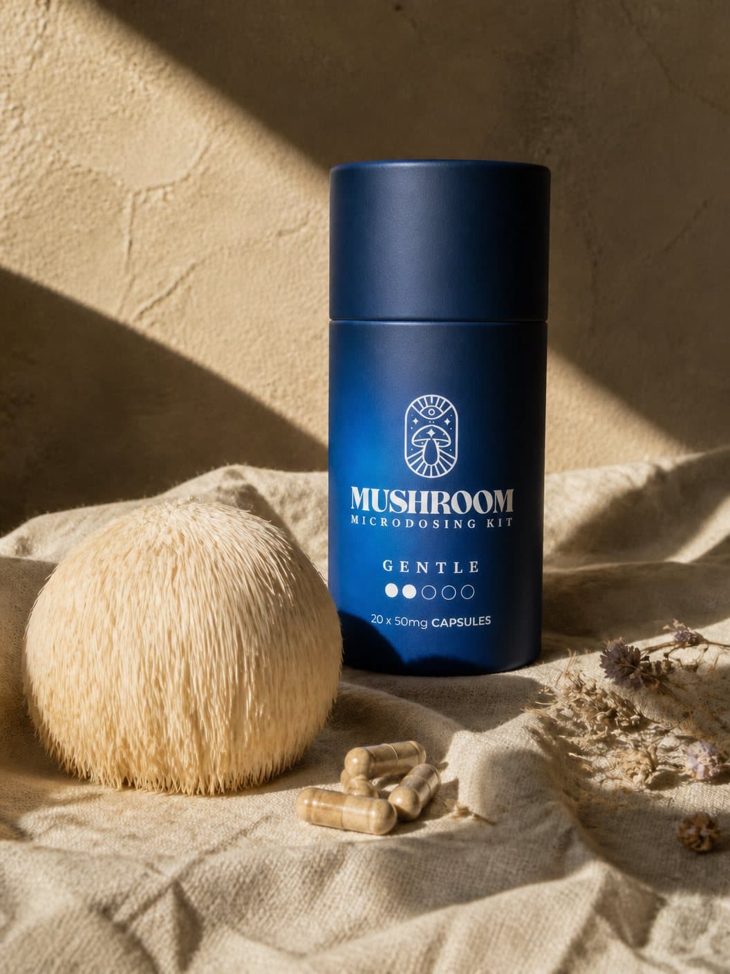 A lion's mane mushroom on rumpled linen, dried herbs around it, hard afternoon sun.